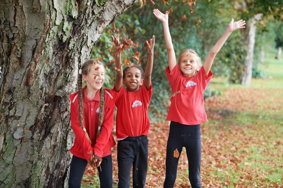 Children throwing leaves
