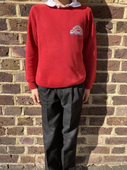 Picture of red sweatshirt with grey trousers