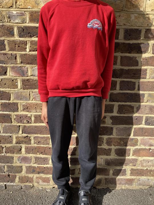 Picture of red sweatshirt with black jogging bottoms